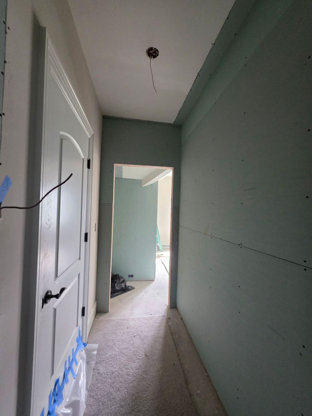 Hallway hung with new drywall, ready for tape