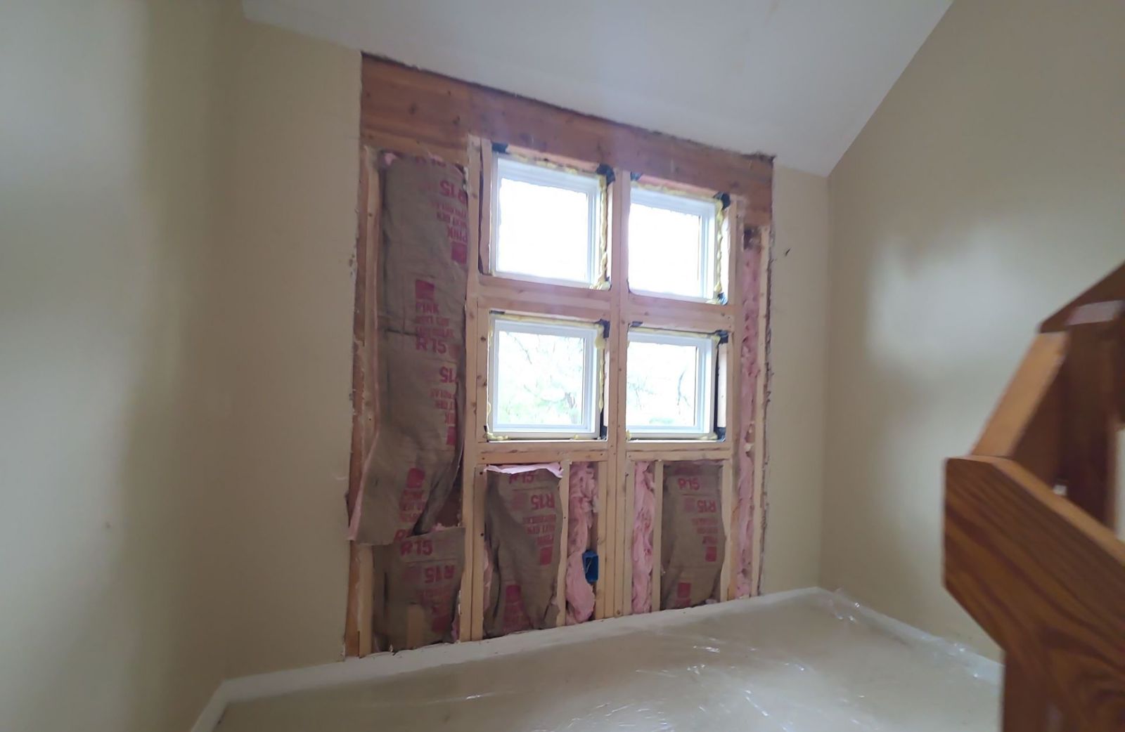 Stairwell wall reframed around new windows